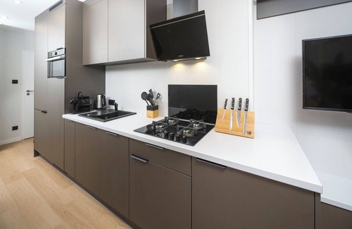 Lieren House | Enjoy a luxury holiday home in the wooded nature of the Veluwe, featuring modern amenities, air conditioning, and a stylish pergola with electric fireplace for optimal comfort.