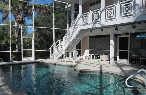 Sanibel House | Key West Style Home. With Screened Heated Pool. Only a 6 Minute Walk To Beach.