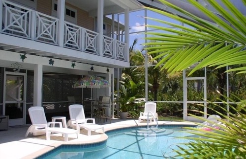 Sanibel House | Key West Style Home. With Screened Heated Pool. Only a 6 Minute Walk To Beach.