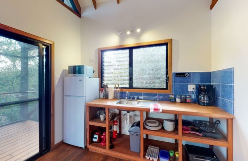 Surfside Cabin | Quiet treehouse cabana with veranda, hammock, WiFi & partial AC - walk to beach