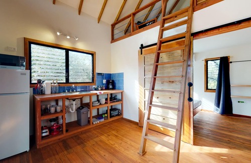 Surfside Cabin | Quiet treehouse cabana with veranda, hammock, WiFi & partial AC - walk to beach