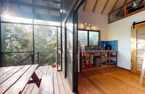 Surfside Cabin | Quiet treehouse cabana with veranda, hammock, WiFi & partial AC - walk to beach