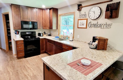 Babcock House | Relax by the river in this 4 bedroom house with firepit- spot our river eagle!