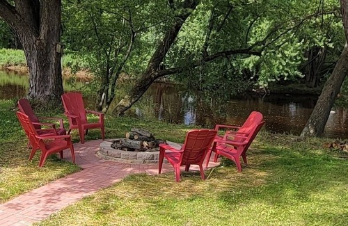 Babcock House | Relax by the river in this 4 bedroom house with firepit- spot our river eagle!