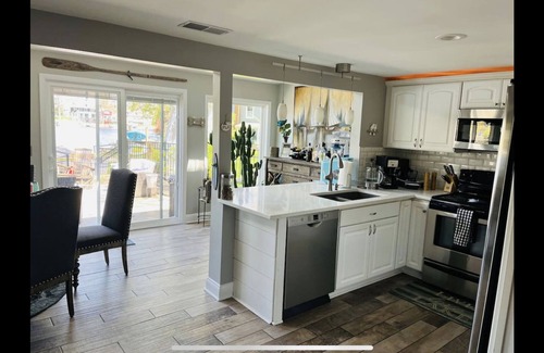 Portage Lakes Cottage | SLICE OF HEAVEN lake front cottage with HOTTUB, fire pit, kayaks & Dog friendly!