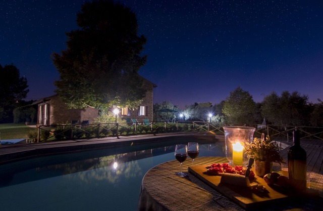 A farmhouse nestled among gardens and olive trees