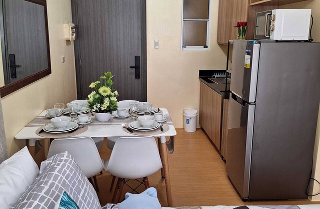 A Fully Furnished Studio Unit with Little Balcony ,Kitchenette, Dining & Living.