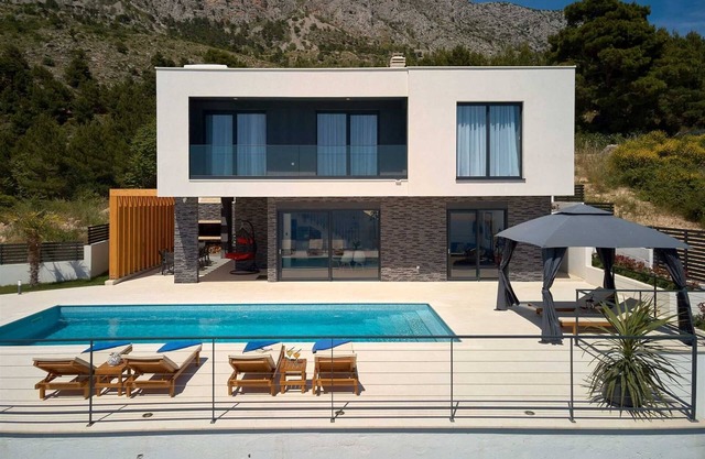A modern villa with a pool and an amazing sea view