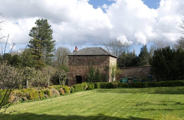 a quirky garden building in an orchard