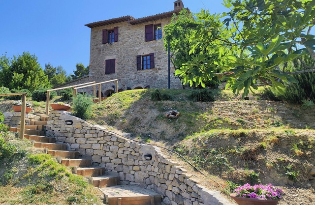 A residence in an old farmhouse with spectacular swimming pool in a large park.