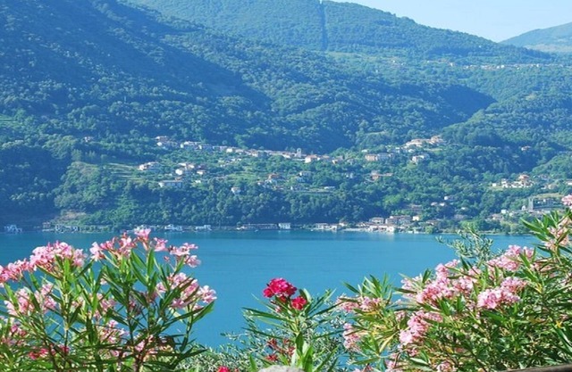 A THREE-STORY VILLA OVERLOOKING THE VEZIO CASTLE &LAKE LUGANO,ITALIAN SIDE