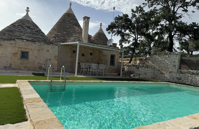 Aprus trullo surrounded by greenery with private pool.