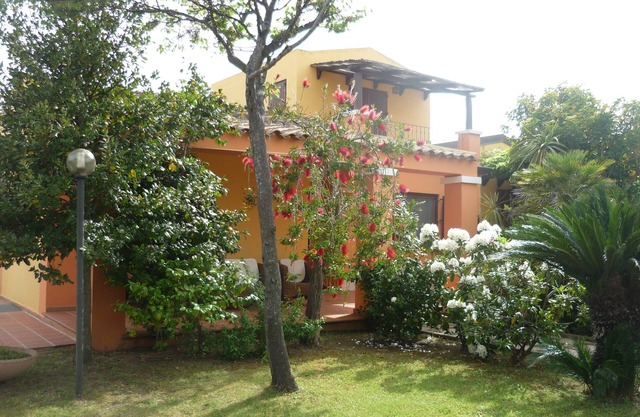 arbatax tortoli: elegant and prestigious villa with green lawn and flowers