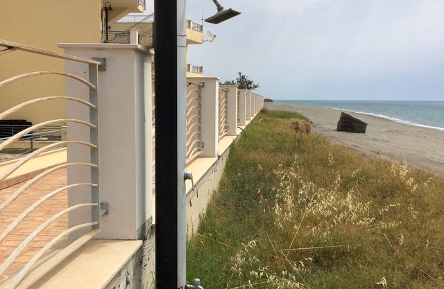 Beachfront apartment in prime position with rooftop terrace, balcony and patio.