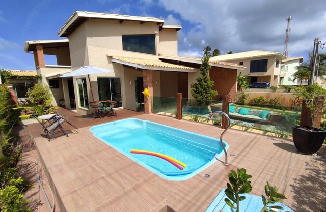 Beautiful furnished 5-suite beach house with swimming pool in gated sea front community.