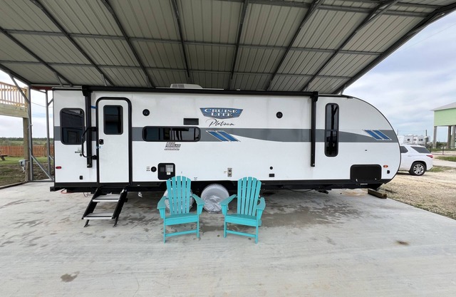 Beautiful NEW 2023 camper covered on concrete slab. Sit and enjoy the barges