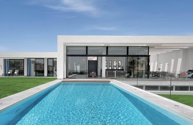 Brand new villa with sea views. Private gym. Walk to beach, restaurants.