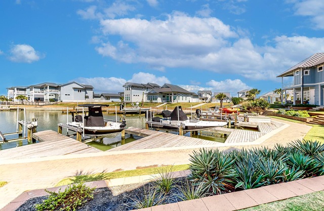 Bright waterfront villa with pool, boat slip, patio & balcony in gated community