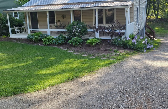 Charming bedroom and bath with private entrance and screened porch .