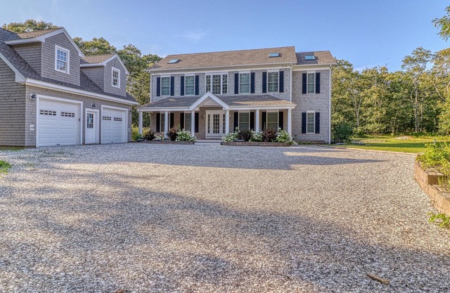 Classic, private estate with a large lot, a stone patio & a fireplace!