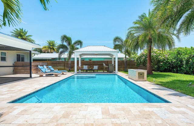 Clean Florida Coastal Design home with Heated Pool, Fireplace and Putt Putt