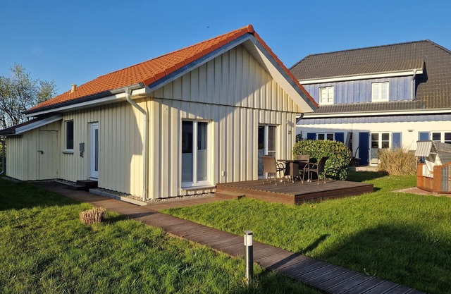 Close to the beach holiday home in a quiet field location with a spacious wooden terrace