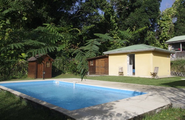Country bungalow in a tropical garden with swimming pool