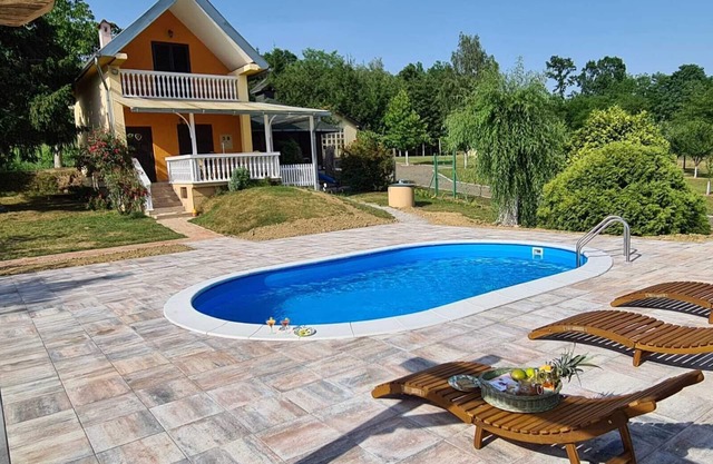 Country house with swimming pool surrounded by pure nature