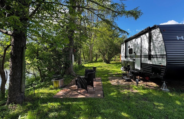 Cozy Riverfront RV with pool and playground in Cortland