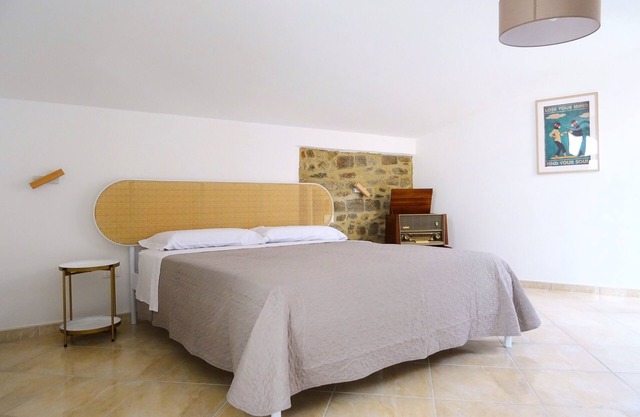 Cozy room on two floors with kitchen and bedroom upstairs.