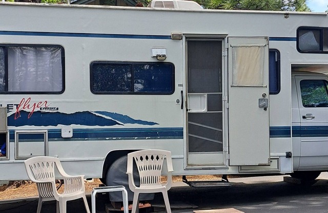 Cute RV in the forested mountains at Cedar Ridge, Sonora for your vacation.