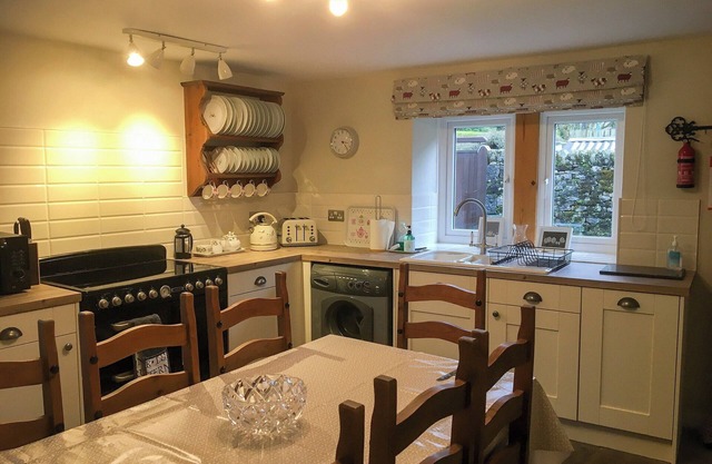 Detached barn conversion with side terrace overlooking the river.