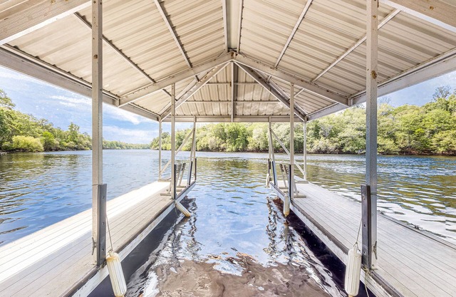 Dog-friendly riverfront home with screened porch, firepit, & private dock