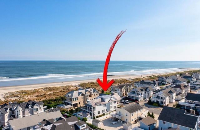 Exceptional 6 bed/6 bath stunner just steps away from the beach