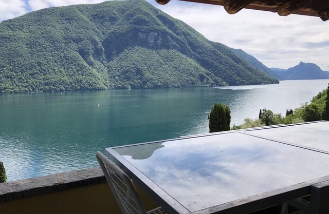 Exclusive penthouse with stunning lake view, large terrace, garden & pool.