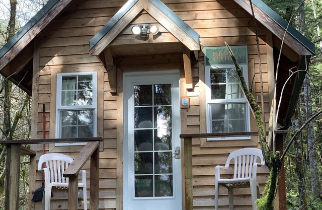 Experience a custom built tiny home cabin near Mt Rainier National Park. It sleeps up to three! Firepit, access to shared hot tub, walking distance to Copper Creek Restaurant