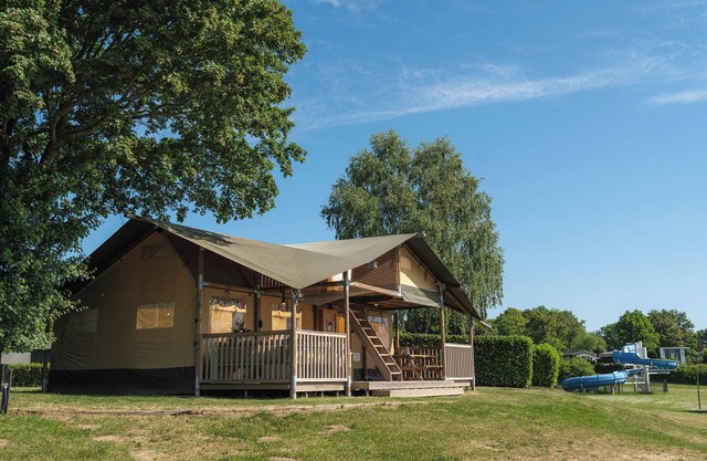 Experience luxury glamping in the elevated Safari Tent Ranger by the water.