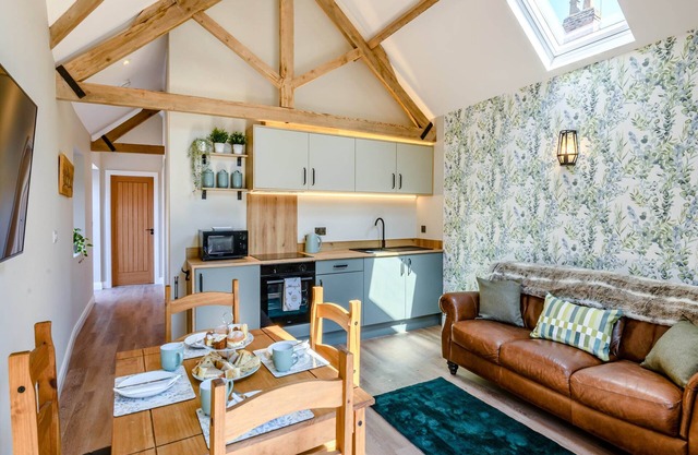 Exposed beams and calming green colours for this holiday home.