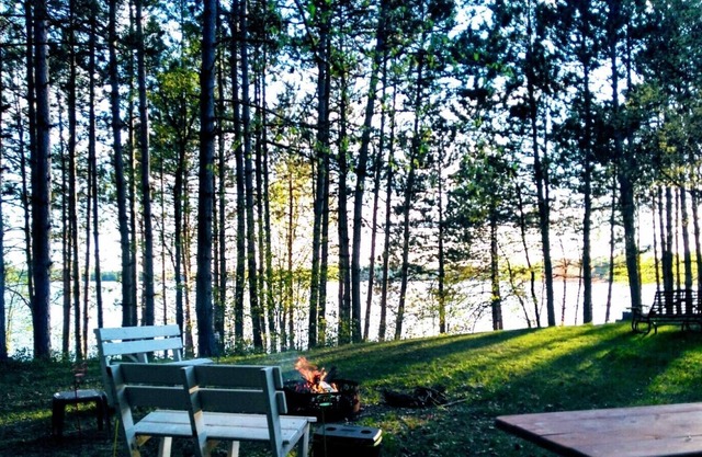 Family vacation lake home with a beach, dock, and boats on Fireside Lake.