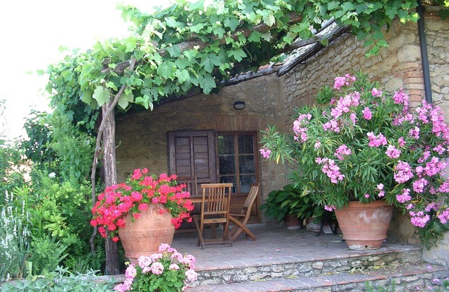 Farmhouse from 17th century with antique furniture and many flowers.