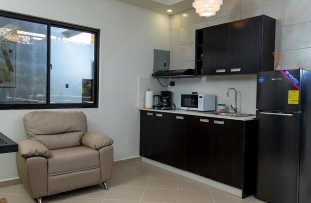 First floor room with small living room and kitchenette