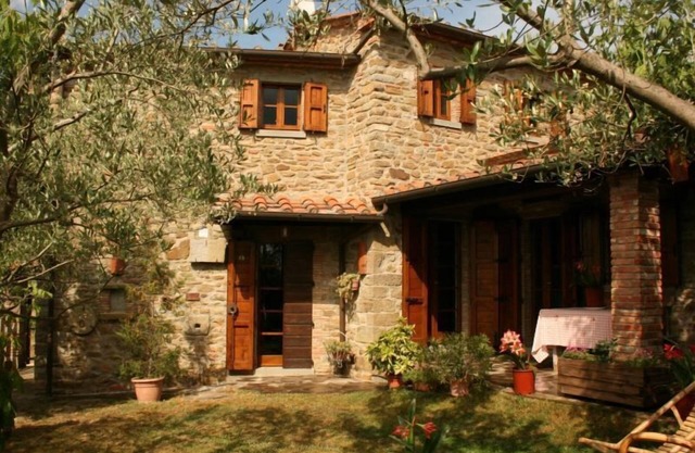 Fully detached and fenced stone farmhouse with an outside porch. Garden equipped with table, chairs,