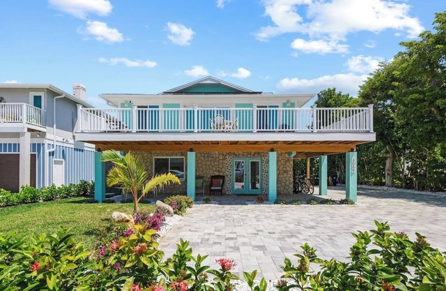 Go to the beach from expansive heated pool home