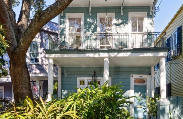 Historic Property With Balcony Lookout into Trees and Pre Civil War buildings.