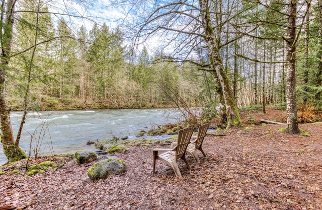 Historic riverfront Steiner cabin in forest with firepit, deck, & patio lounging