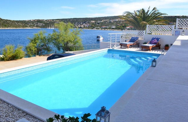 Holiday beach house with private heated pool and buoy