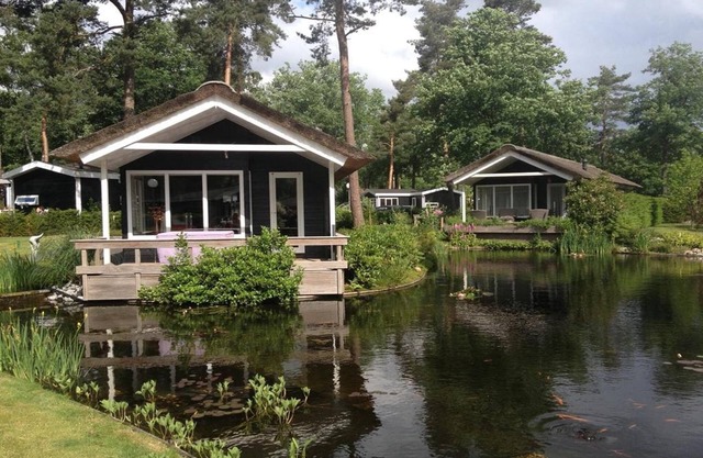 House on water, surrounded by nature