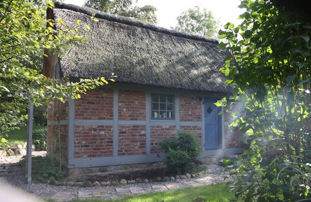 Hunting lodge under thatch on an idyllic horse farm