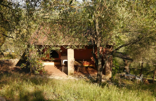 Idyllic cottage on hill near sea