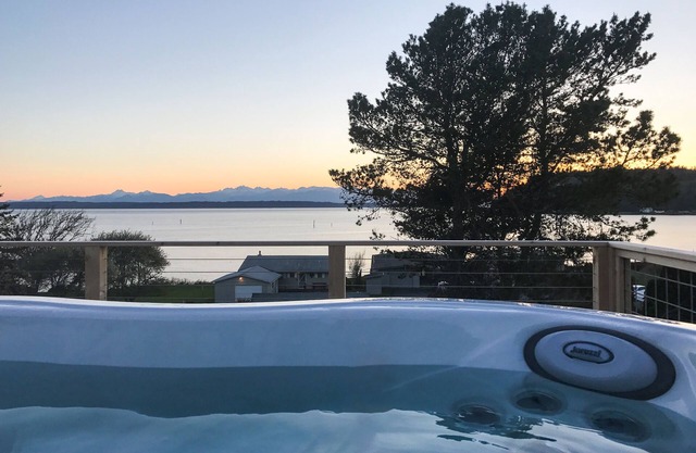 Inviting Puget Sound view home with beach access, fire table, hot tub, & W/D